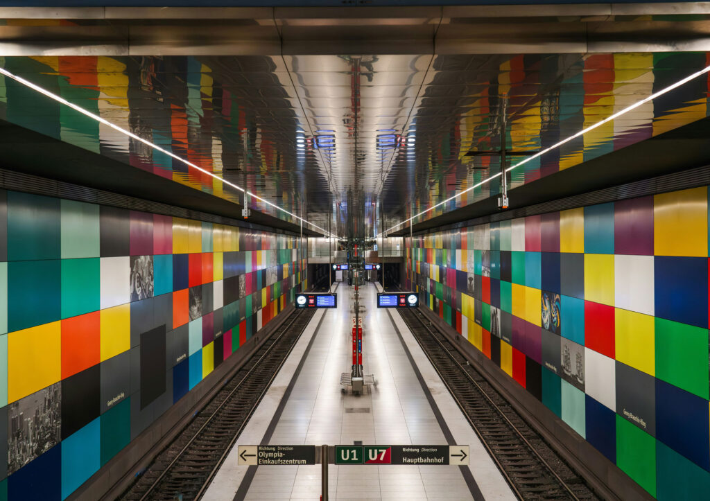 A subway station with colourful tiles on the walls
