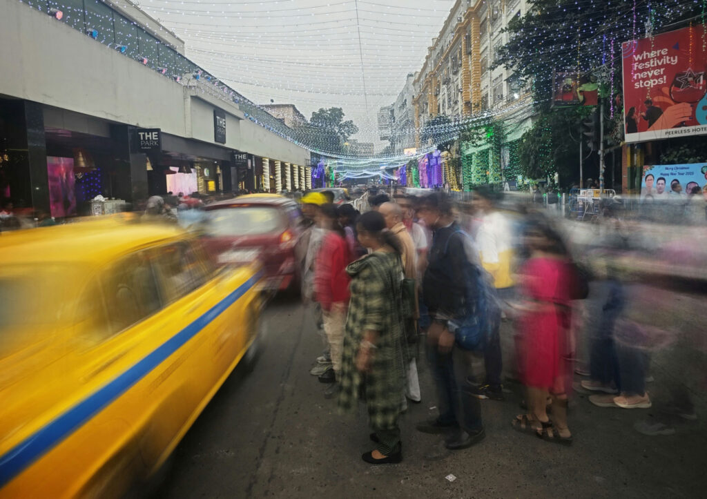 A blurry shot of a busy city street with festive decorations