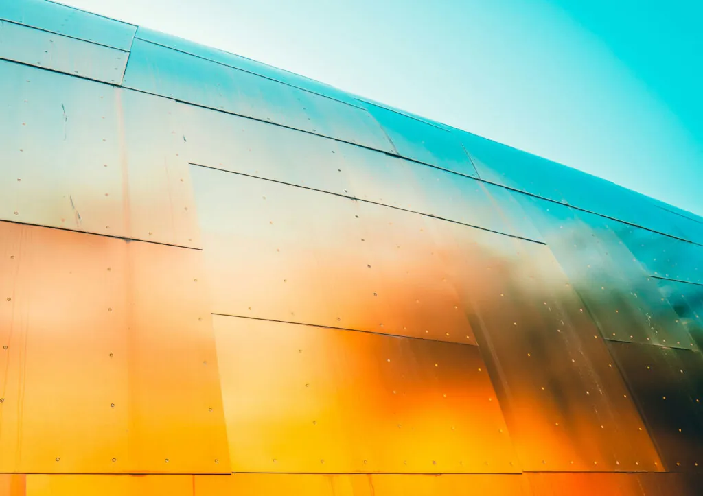 An orange and blue metallic wall up close