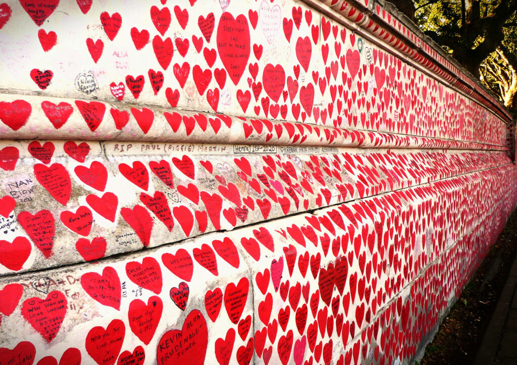 A white wall filled with painted hearts