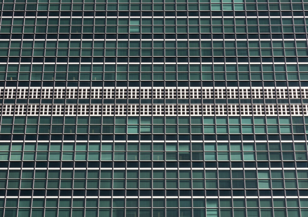 A front view of a modern building with a large amount of windows