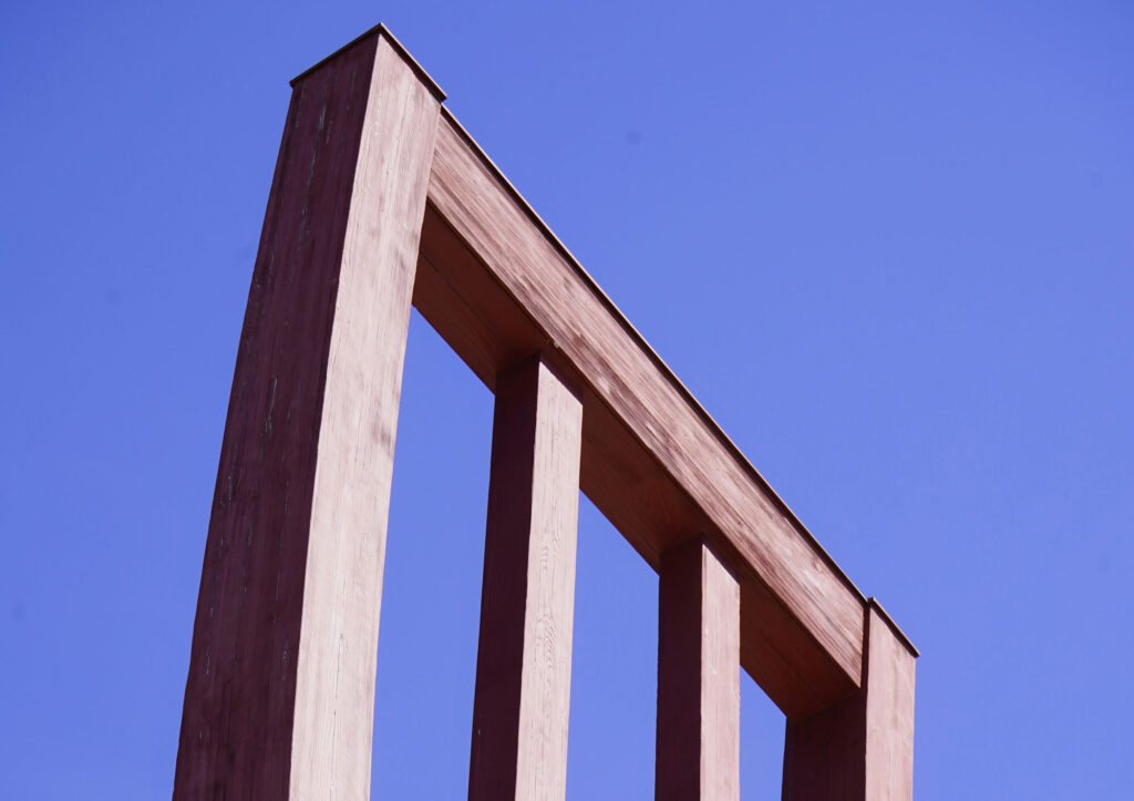 A wooden structure with a blue sky background