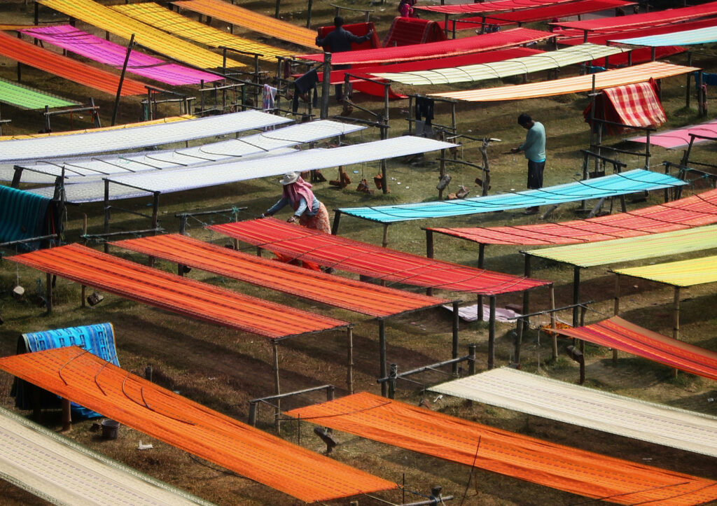 A group of people stretching fabrics